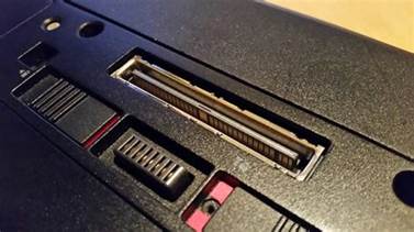 a close up picture of a port on the bottom of a laptop. this port is used for docking older laptops with specific docks. 